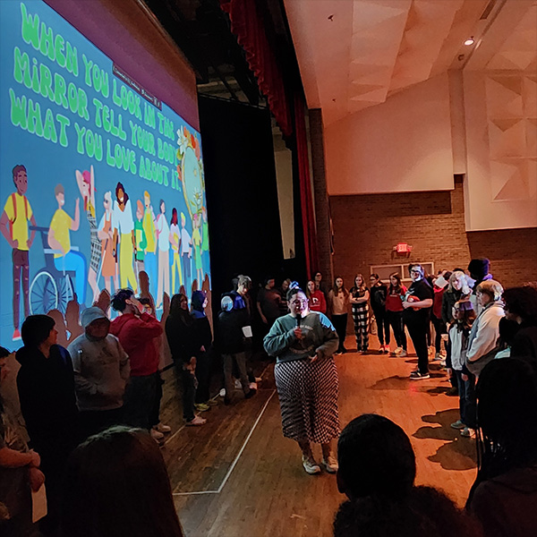 Danielle educating a large group of peers.