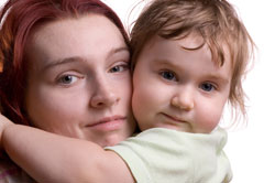 mother holding daughter close to her in a close up