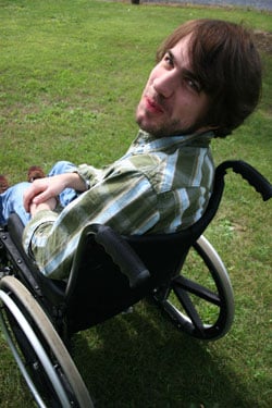 Teen looking up at the camera from a wheelchair