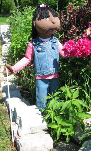 Gina the puppet, standing on the playground platform.