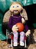 Sally the puppet, holding a ball on a playground.