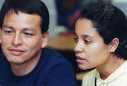 man and woman both looking ahead at something outside the realm of the photo